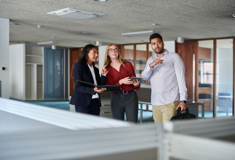 estate agent showing prospective tenant the office space