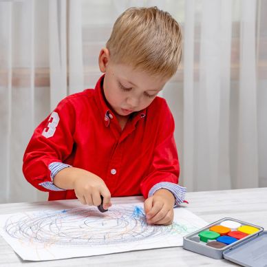 Young boy focused on drawing.