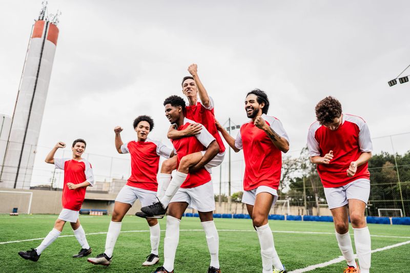 Soccer players celebrating a goal on soccer field