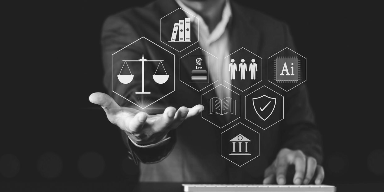 Man in suit holding his hand out to several floating legal icons, such as a legal scale.