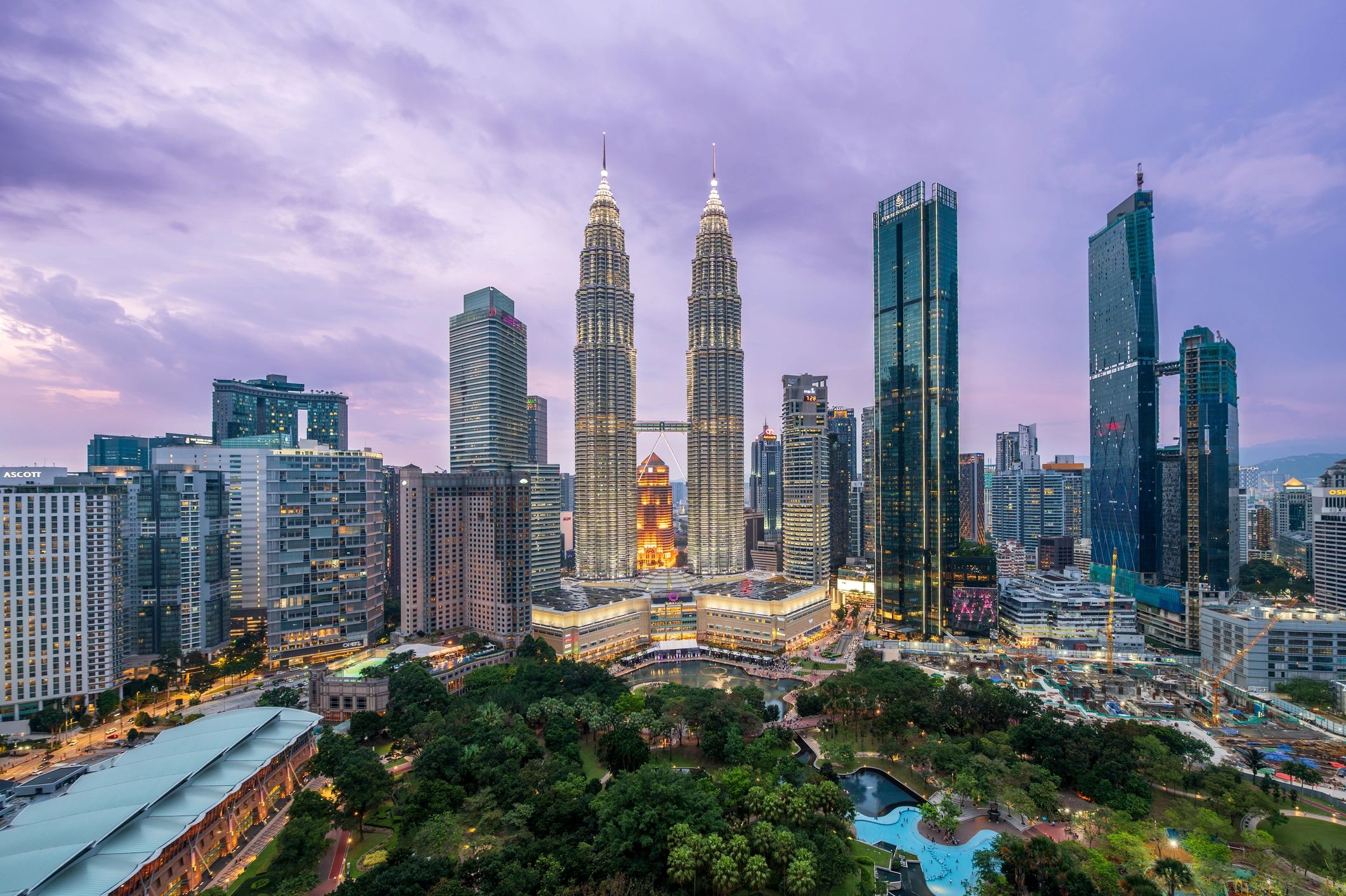 Kuala Lumpur city skyline with the Petronas Twin Towers at dusk.