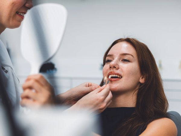 Dentist performing cosmetic dentistry on an adult patient in Christian County, KY.