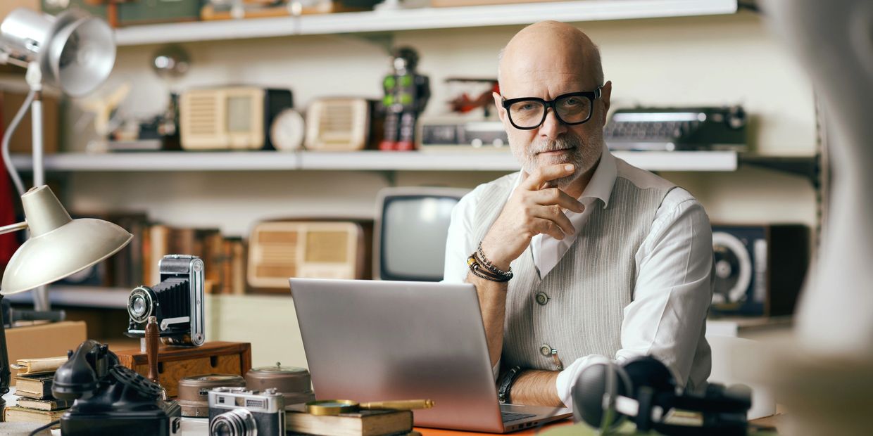 Thoughtful man working in a vintage-themed study.