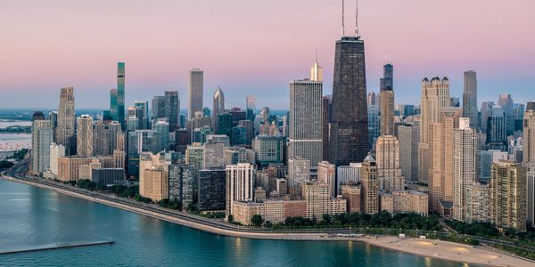 A panoramic view of Chicago skyline at sunset by Lake Michigan.