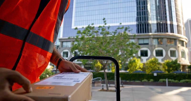 Platform truck POV shot of package being placed on the dolly.
