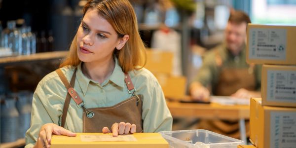 Woman packing boxes in a warehouse.