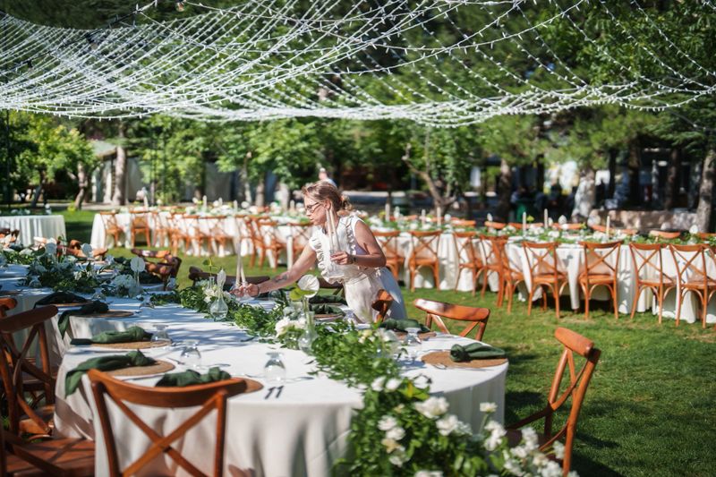 Moments of the team working on floral decorations for a wedding event.