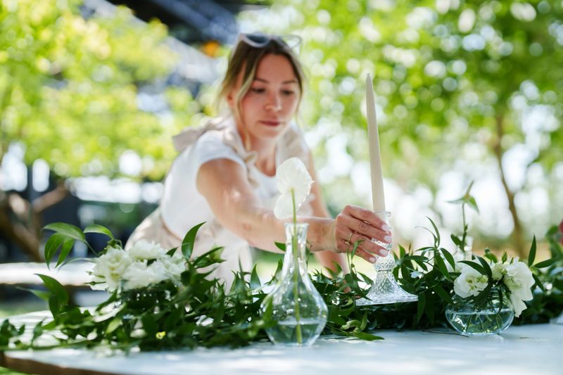 Moments of the team working on floral decorations for a wedding event.