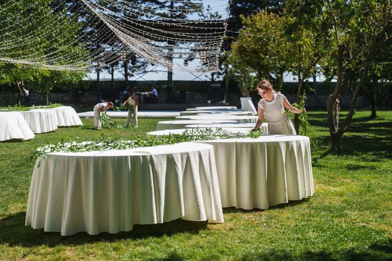 Moments of the team working on floral decorations for a wedding event.