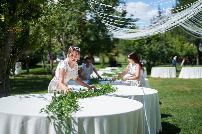 Moments of the team working on floral decorations for a wedding event.