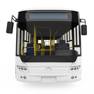 Front view of a white city bus with visible seats and steering wheel.