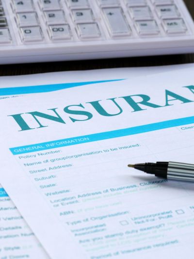 Insurance form with pen and keyboard in the background.