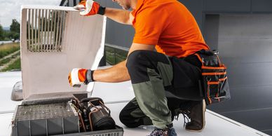 Tech working on a rooftop AC