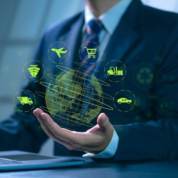Businessman holding a digital globe with logistics icons.