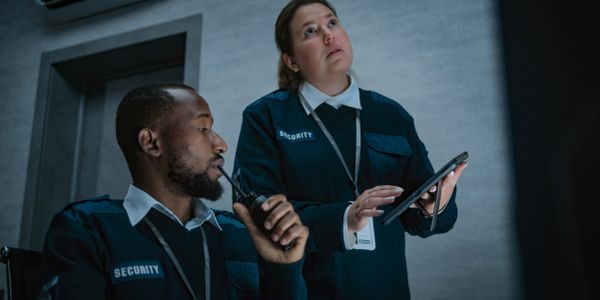 Two security officers on duty communicating and monitoring.