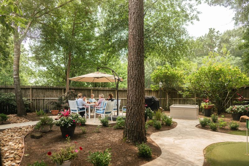 Senior friends sitting in the backyard. They are having coffee, dessert and drinks together. Part of a series where we follow a group of seniors living in the larger Houston area, Texas.