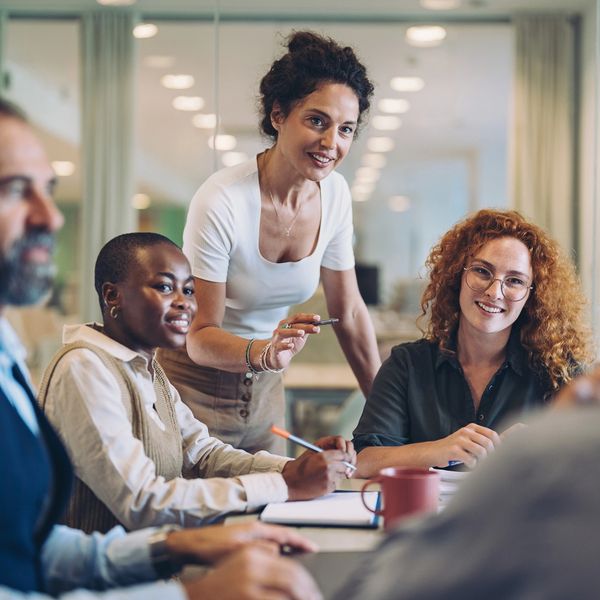 Team meeting with a woman leading a discussion.