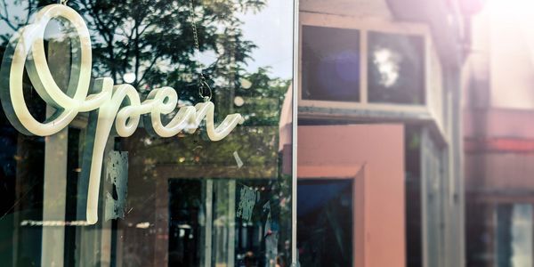 "Open" sign in business window