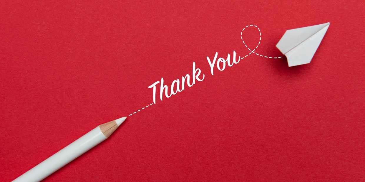 White pencil and paper plane with "Thank You" on red background.