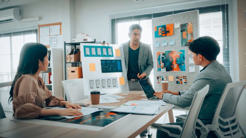 Team Analyzing Mobile App Interface Designs in Office