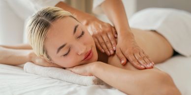 A woman enjoying a relaxing back massage at a spa.