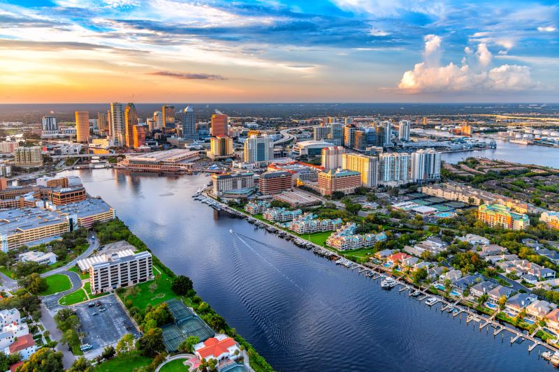Aerial view of downtown Tampa, Florida from over the Seddon Channel with a clear view of Harbour Island and its waterfront homes with private boat docks shot via helicopter from an altitude of about 900 feet.