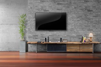 Flat screen mounted to stone wall with a flat mount. 