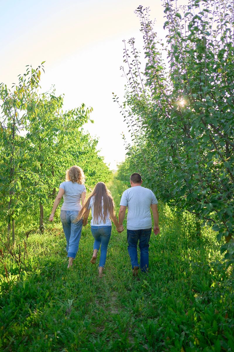 parents and their teenage daughter in the park