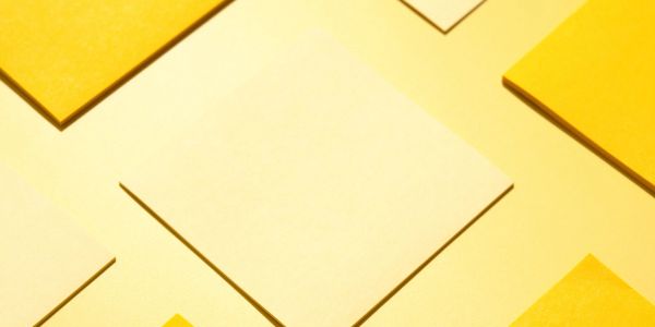 Blank yellow sticky notes arranged in a pattern.