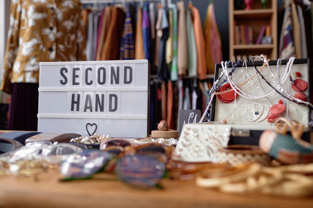 Second-hand items displayed with a sign.