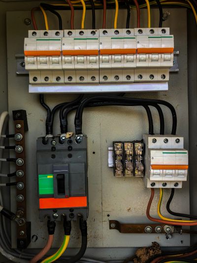 Electrical circuit breakers and wiring inside a panel.