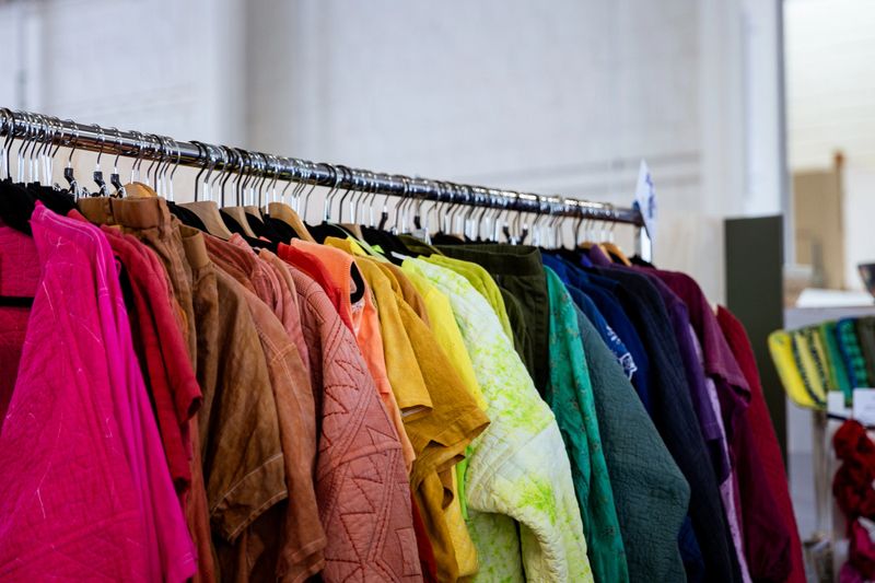 Colorful fashionable Vibrant Clothing Rack at a Thrift Store in Seattle Washington State USA. Clothing is vintage and has been recycled and made stylish again.