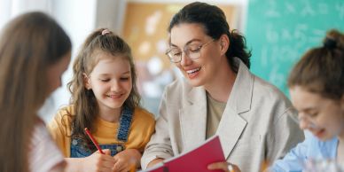 Teacher helping students in class.