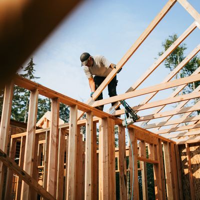 Construction worker framing a building structure on an industrial jobsite in BC