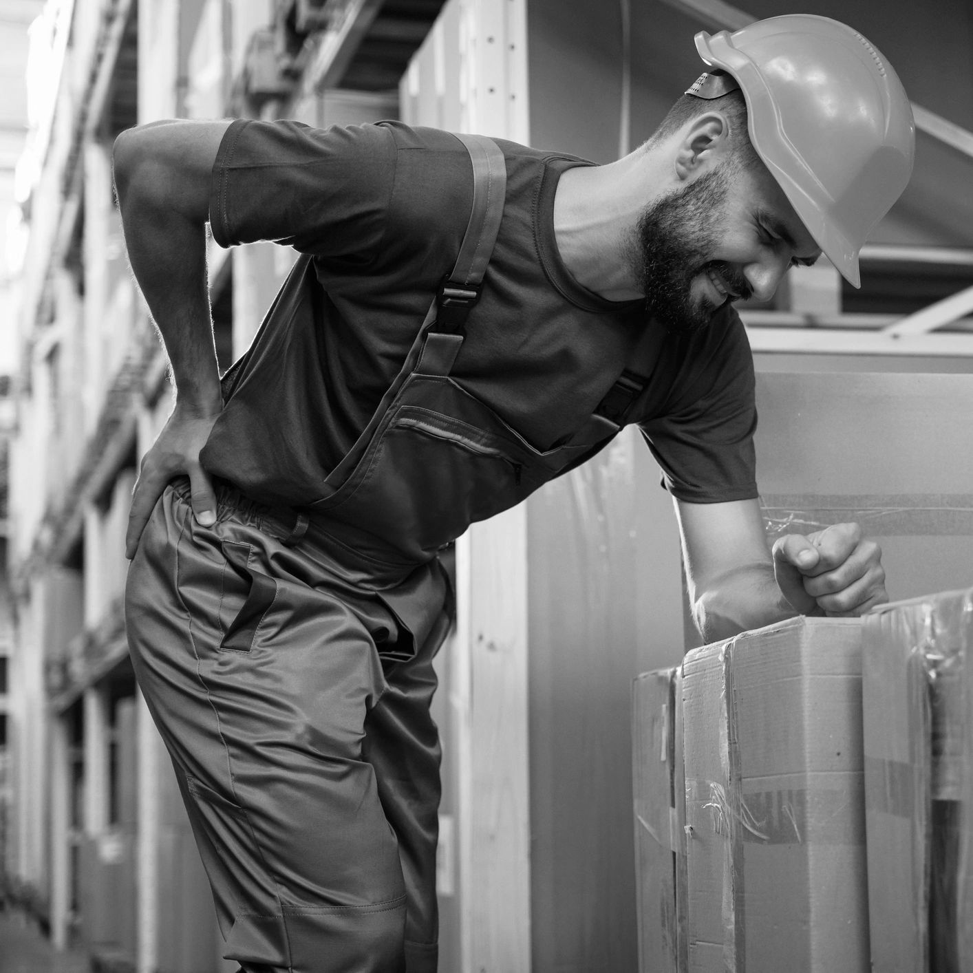 Person holding back in pain-in need of a Workers compensation lawyer