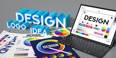 Creative workspace with design, logo, and color theory elements on a tablet and papers.