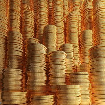 Tall stacks of golden coins arranged closely together.