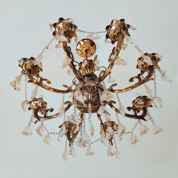 Ornate gold chandelier with crystal accents.