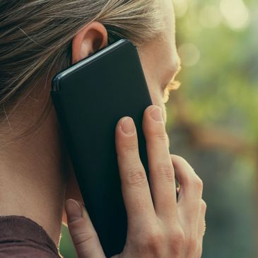 A woman holding a mobile phone to her ear