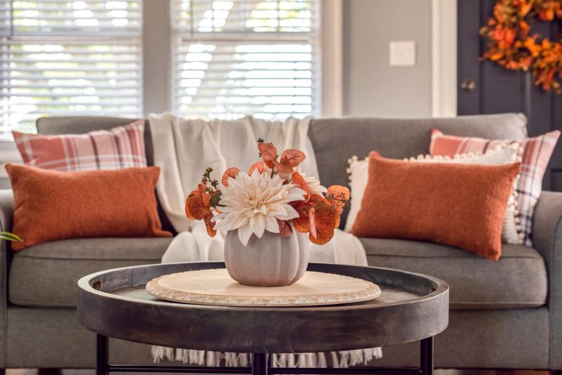 Fall floral arrangement on a coffee table in a cozy living room