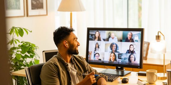 Man participating in a video conference from his home office.