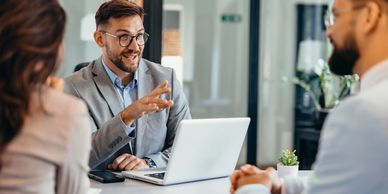 Businessman explaining a point during a meeting with colleagues.