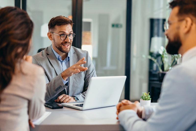 Shot of group of business persons in business meeting. Three entrepreneurs on meeting in board room. Corporate business team on meeting in modern office. Male manager discussing new project with his colleagues. Company owner on a meeting with two of his employees in his office.