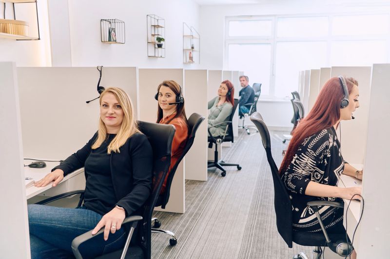 A dedicated team of women work together in a call center, providing assistance and support to clients over the phone with professionalism and efficiency.