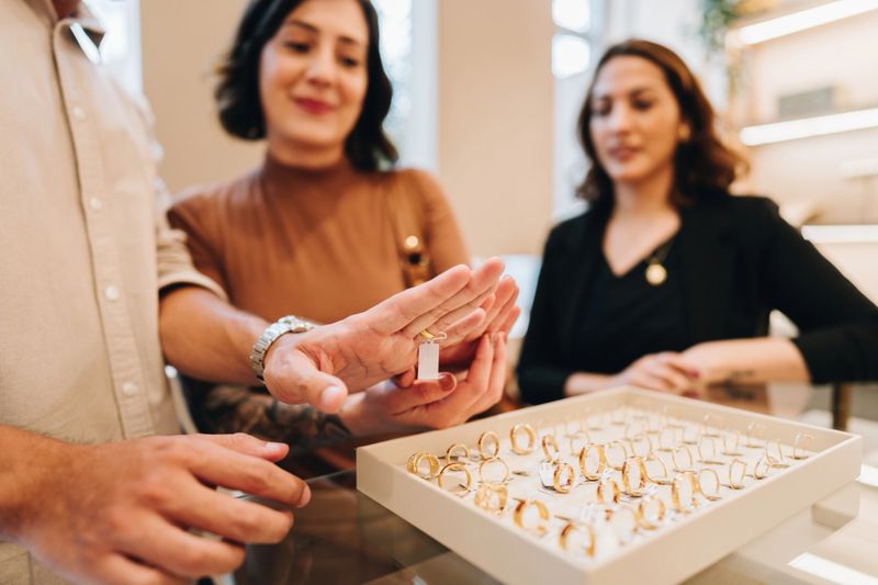 Close-up of a man trying a ring on jewelry store