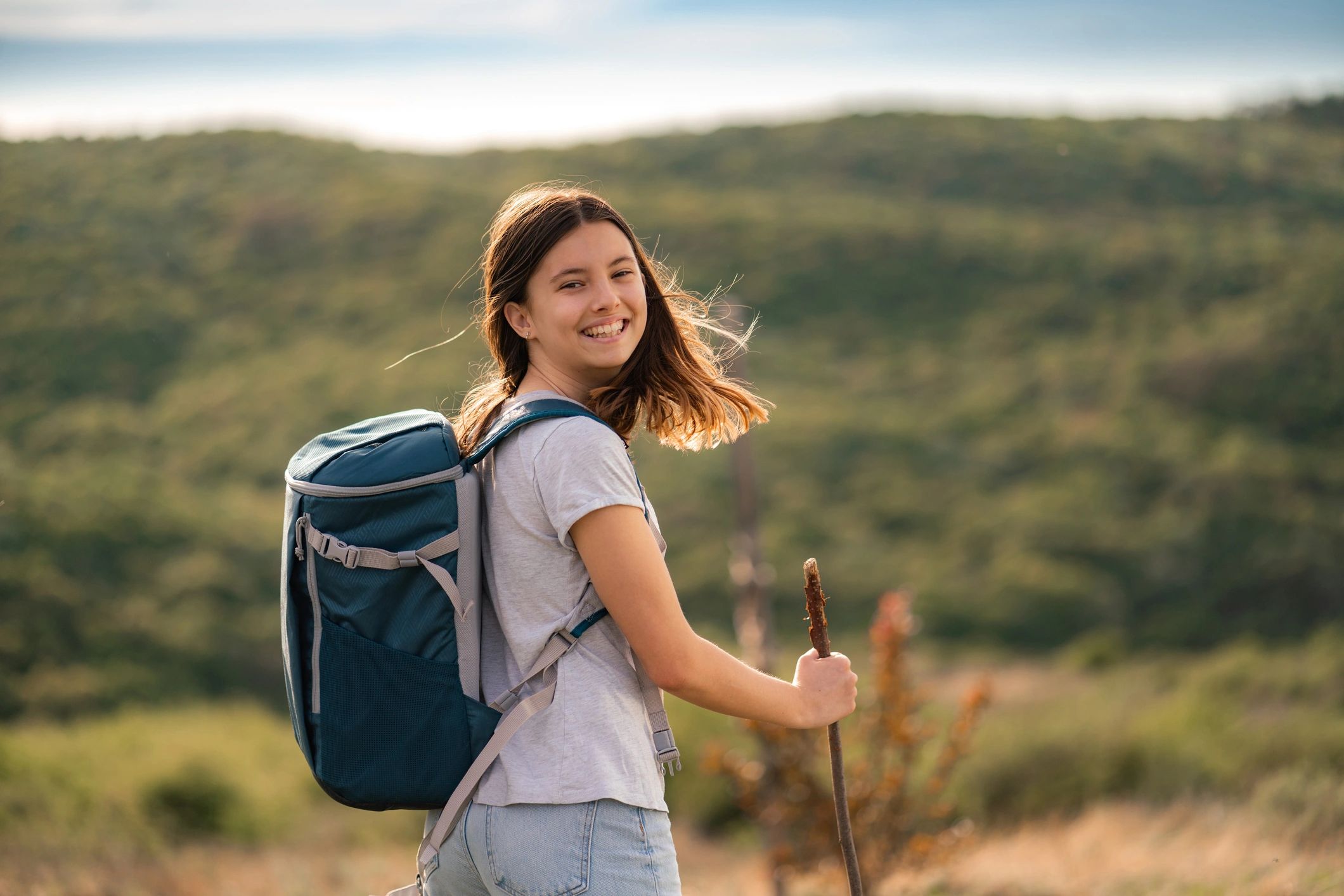 Woman with hiking backpack for outdoor adventure.