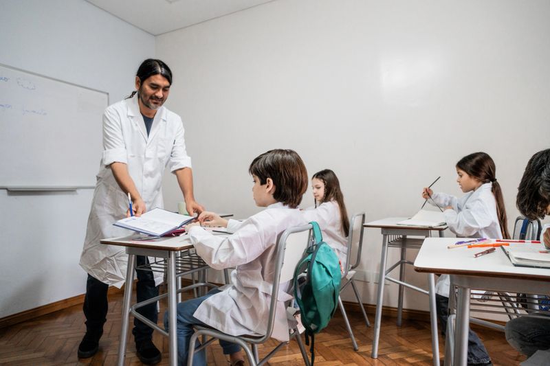 Teacher helping student in the classroom