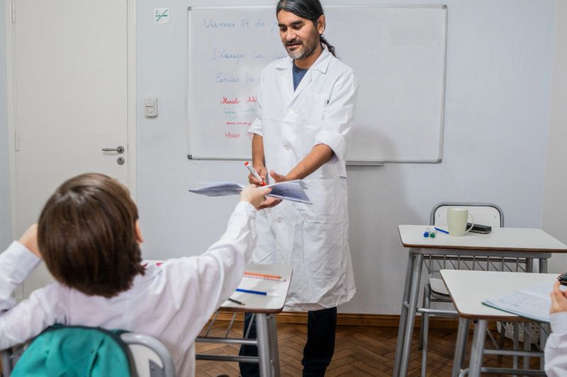 Teacher helping student in the classroom
