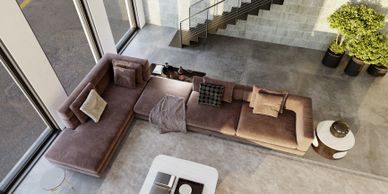 modern living room with a spacious and minimalist design. The room features a neutral-toned sectional sofa arranged comfortably for relaxation, paired with soft throw pillows. A stylish coffee table sits at the center, with decorative items that add elegance to the space.