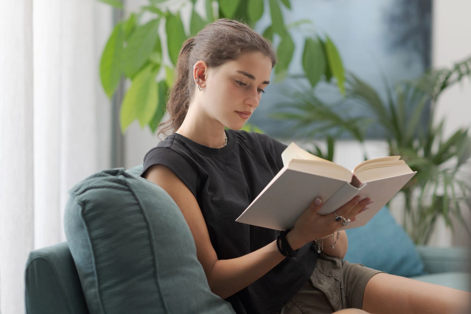 Young woman reading on couch.